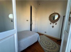 a bedroom with a bed and a mirror on the wall at Agora House for men only 仅限男性 in Alexandria