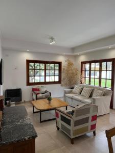 a living room with a couch and a table at Casa Franklin, A media cuadra de la laguna! in Chascomús