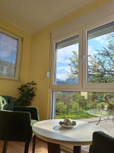a living room with a table and a window at Apartman Sara in Plužine