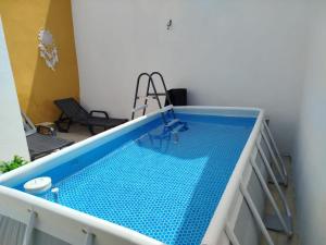 a swimming pool with blue tiles on a balcony at Casa dos Marias in Elvas
