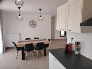 a kitchen with a table and chairs in a room at Sologne Escape in Tour-en-Sologne
