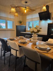 a dining room with a wooden table and chairs at Apartman Magic View in Baška Voda
