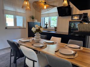a dining room table with chairs and a kitchen at Apartman Magic View in Baška Voda +35 photos