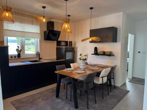 a kitchen and dining room with a table and chairs at Apartman Magic View in Baška Voda
