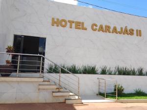 a hotel caravas building with a sign on it at Hotel Carajás II in Canaã dos Carajás