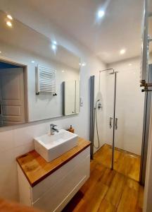 a bathroom with a white sink and a shower at Dom Nad Jeziorem z Jacuzzi in Mrągowo +23 photos
