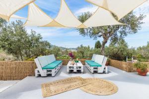 a patio with two chairs and a table at Iris Home - Paws Getaway in Skopelos Town