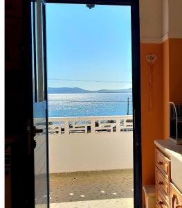 an open door with a view of the ocean at Naxos Crafts' House in Naxos Chora