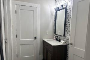 a bathroom with a sink and a mirror at 2 Midtown Atlanta's Roller-Coaster in Atlanta +18 photos