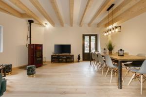 a dining room with a table and chairs and a tv at Casa Cabalero in Fago
