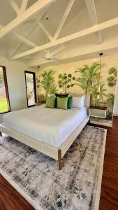 a bedroom with a large bed with a rug at Port Douglas Alamanda Estate w Ocean Views & Pool in Craiglie