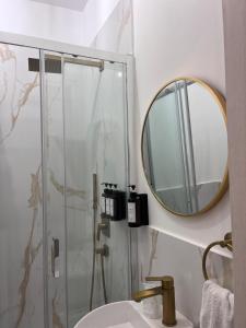 a bathroom with a shower and a sink and a mirror at Guest house thats amore roma in Rome