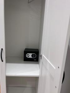 a small radio sitting on a shelf in a closet at Guest house thats amore roma in Rome