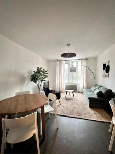 a living room with a table and a couch at L evasion familiale in Mulhouse