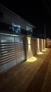 a garage door with lights on the side of a building at Aconchego da Família de Oliveira in Camboriú