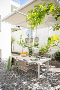 a white table and chairs on a patio at Lemontrees Residences in Rhodes Town