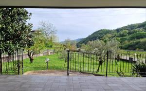 an open gate with a view of a field at HolidHome - Casa di Francesco in San Giovanni Ilarione