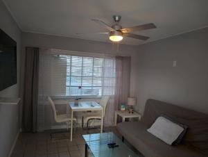 a living room with a couch and a table at Tropical Sky Ranch Motel in Clearwater Beach