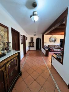 a living room with a tile floor and a ceiling at Mini-Villa à deux pas de la plage in Cabo Negro