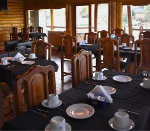 a dining room with tables and chairs with black table cloth at EL Portal Gualeguaychú in Gualeguaychú