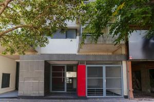 a building with a red door in front of it at Candioti I Apartment - Santa Fe in Santa Fe