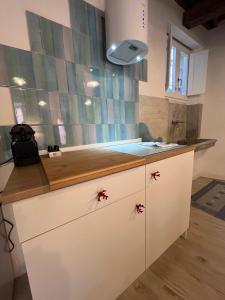 a kitchen with a white counter with a sink at Il Pescatore in Marciana Marina