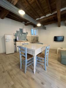 a kitchen with a table and chairs in a room at Il Pescatore in Marciana Marina +12 photos