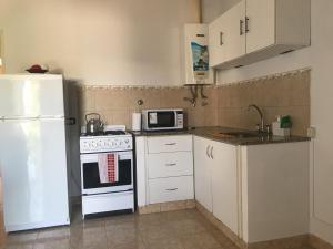 a kitchen with a white stove and a microwave at Carballo de Cereixo - Solo con seña in Federación