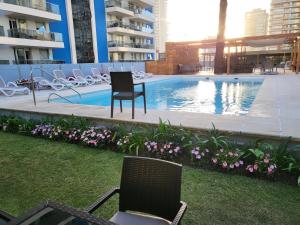 a patio with chairs and a swimming pool at Forest2 - 1306 in Punta del Este