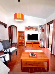 a living room with a tv and a coffee table at CAN HOST YUMBO - Private Terrace AA in San Bartolomé de Tirajana
