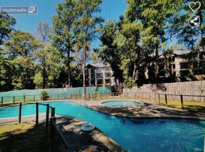 a swimming pool in front of a building at Departamento Pucon Parque in Pucón