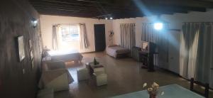 a living room with a couch and a bed at Loft Necochea in Necochea