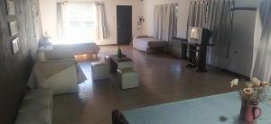 a living room with a couch and a tv at Loft Necochea in Necochea