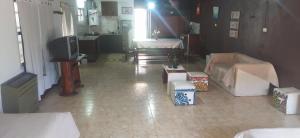 a living room with two beds and a television at Loft Necochea in Necochea +2 photos