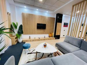 a living room with a couch and a table at Casa Epidamnos in Durrës
