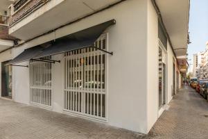 a white building with a window with bars on it at Luxury Apartment Mª Luisa Park & Plaza de España in Seville
