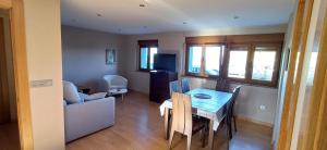a living room with a table and a couch at Vista marina VUT-7215-AS in Bañugues