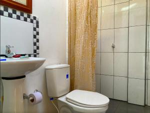 a small bathroom with a toilet and a sink at Lakeview Apartment in the Heart of Guatavita in Guatavita
