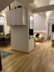 a living room with white cabinets and a dining room at Holiday Let In Mazury !! in Szczytno +22 photos
