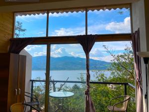 a window with a view of a lake and mountains at Lakeview Apartment in the Heart of Guatavita Bunk bed for Kids in Guatavita