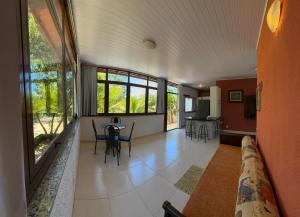 a living room with a table and chairs at Tapuio Park Hotel in Cavalcante