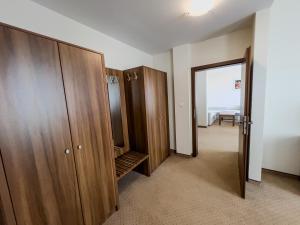 a hallway with wooden cabinets and a door to a room at Hotel Arman in Nižná