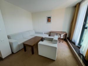 a living room with a white couch and a table at Hotel Arman in Nižná