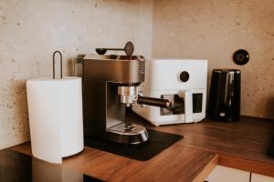a kitchen counter with a mixer and a paper towel at Kamienna Azyl - domek z sauną i balią w Sudetach in Kamienna
