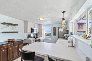 a kitchen with a white table and chairs in it at Sea Legs | Flagler Beach in Flagler Beach