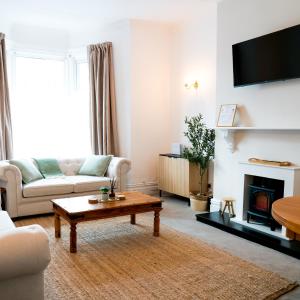 a living room with a couch and a coffee table at Luxury seaside getaway Whitley Bay in Whitley Bay