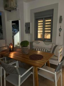 a wooden table with chairs and a dining room at Faros Anaplioti in Kalymnos