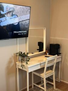 una scrivania con specchio e una TV a parete di East Guesthouse a Egilsstadir