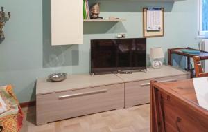 A television and/or entertainment centre at Cozy Apartment In Marina Di Santangelo