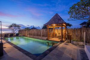a swimming pool with a gazebo in a backyard at Villa Senja in Nusa Lembongan